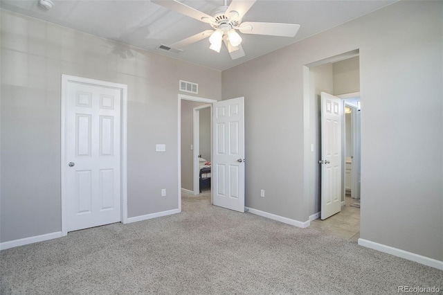 unfurnished bedroom with light colored carpet and ceiling fan