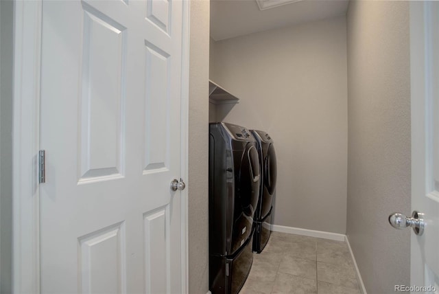 washroom featuring independent washer and dryer and light tile patterned flooring