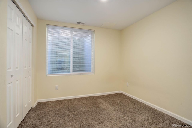 unfurnished bedroom featuring carpet floors and a closet