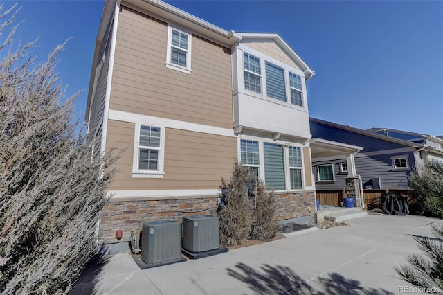 back of property with a patio and central air condition unit