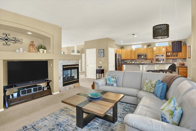 living room with light carpet and a fireplace