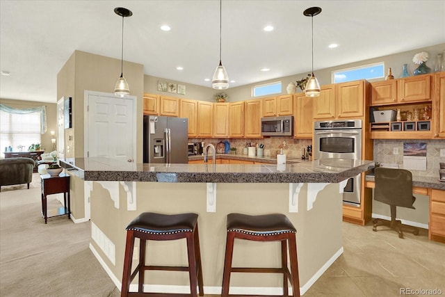 kitchen featuring decorative light fixtures, tile countertops, a breakfast bar, decorative backsplash, and stainless steel appliances