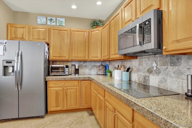 kitchen with tasteful backsplash, tile countertops, appliances with stainless steel finishes, a toaster, and light tile patterned floors