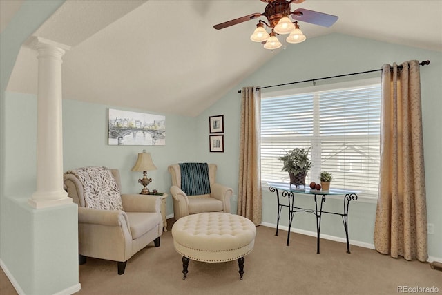 sitting room featuring vaulted ceiling, carpet flooring, and ornate columns