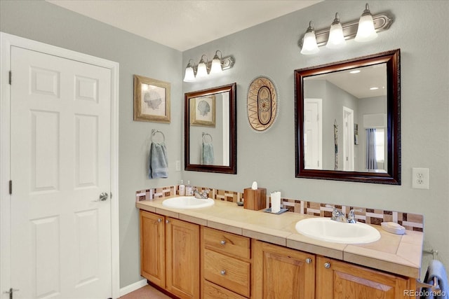 full bathroom with double vanity, tasteful backsplash, and a sink