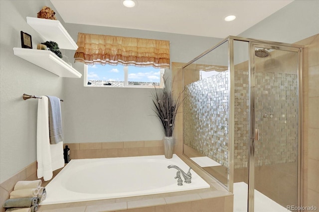 bathroom with recessed lighting, a stall shower, and a bath