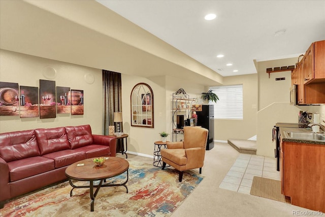 living area with recessed lighting, baseboards, light colored carpet, and light tile patterned floors