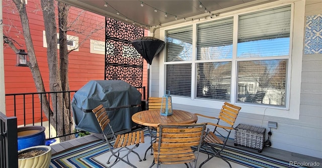 wooden deck featuring a grill