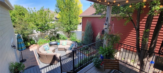 wooden terrace featuring outdoor lounge area