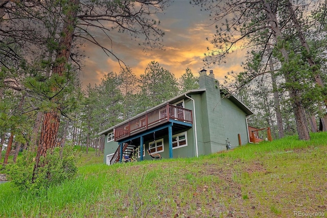 5237 S Olive Rd, Evergreen, CO 80439 - back of house at dusk featuring a deck and a chimney