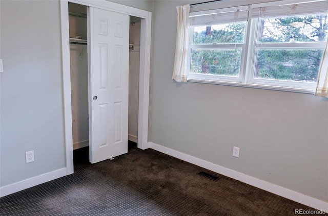 5237 S Olive Rd, Evergreen, CO 80439 - unfurnished bedroom featuring dark carpet, baseboards, and a closet
