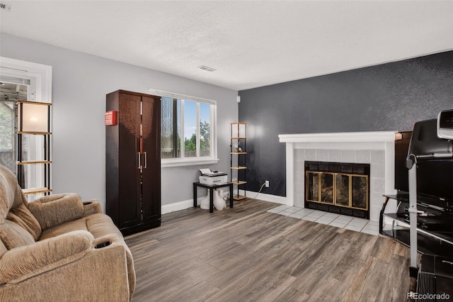 6034 S Parfet St, Littleton, CO 80127 - living room featuring wood finished floors and a tiled fireplace