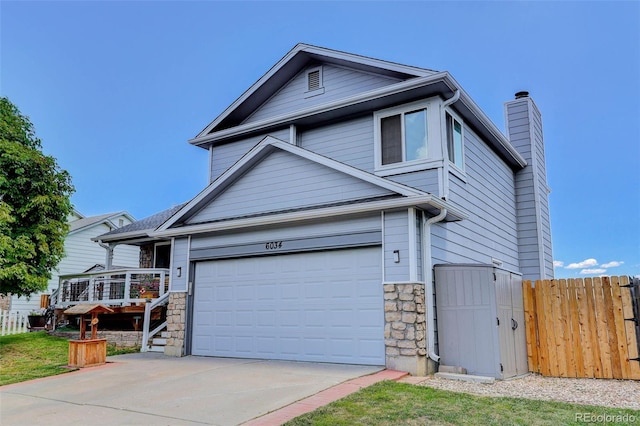 6034 S Parfet St, Littleton, CO 80127 - traditional-style home featuring stone siding, concrete driveway, and a chimney