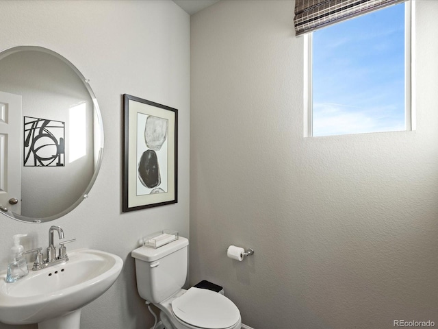 bathroom with toilet and sink