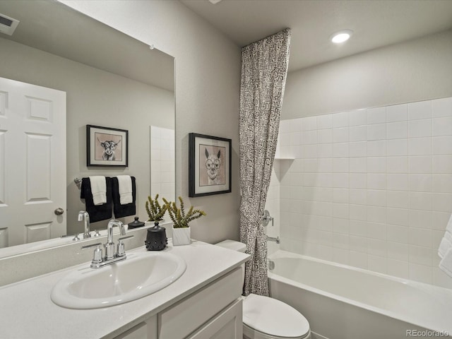 full bathroom featuring shower / bath combo with shower curtain, toilet, and vanity