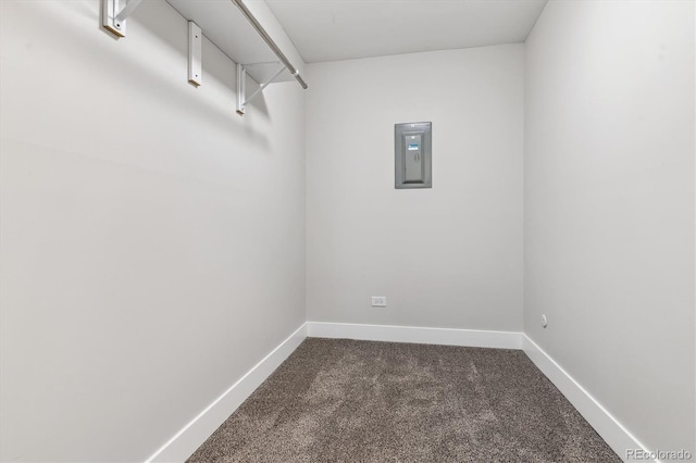 spacious closet with dark carpet and electric panel