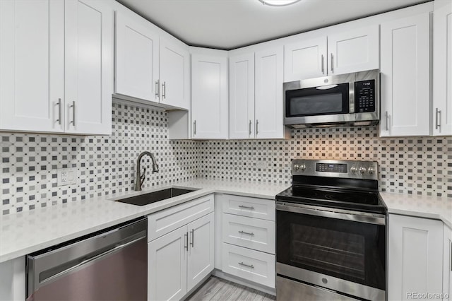 695 S Alton Way Unit 5A, Denver, CO 80247 - kitchen with stainless steel appliances, light countertops, white cabinetry, and tasteful backsplash