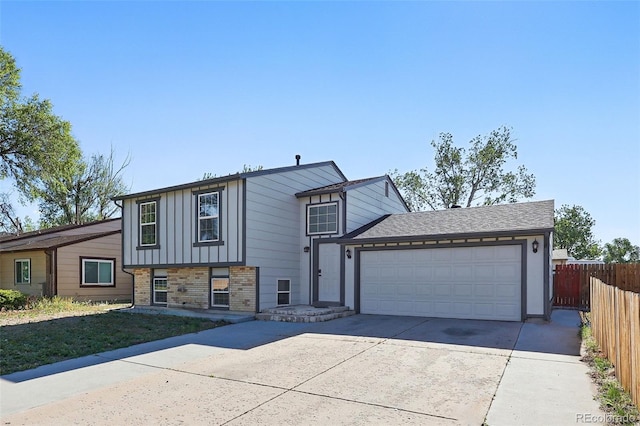 5202 Dillon St, Denver, CO 80239 - tri-level home with fence, brick siding, driveway, an attached garage, and board and batten siding