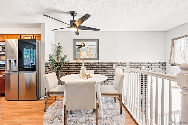 5202 Dillon St, Denver, CO 80239 - dining area featuring healthy amount of natural light, a ceiling fan, a textured ceiling, and light wood-type flooring