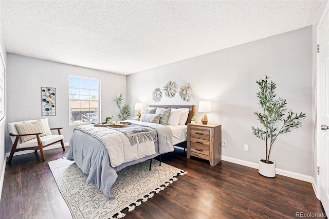 5202 Dillon St, Denver, CO 80239 - bedroom featuring a textured ceiling, dark wood-style floors, and baseboards