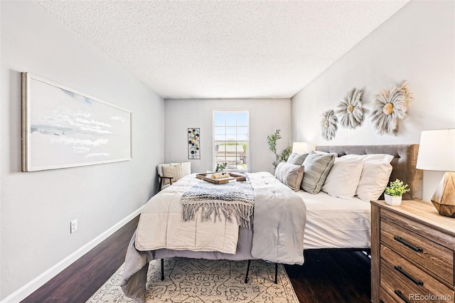 5202 Dillon St, Denver, CO 80239 - bedroom featuring dark wood-type flooring, baseboards, and a textured ceiling