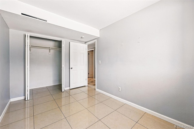 5202 Dillon St, Denver, CO 80239 - unfurnished bedroom with baseboards, a closet, and light tile patterned floors