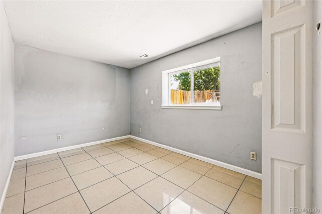 5202 Dillon St, Denver, CO 80239 - tiled spare room with baseboards