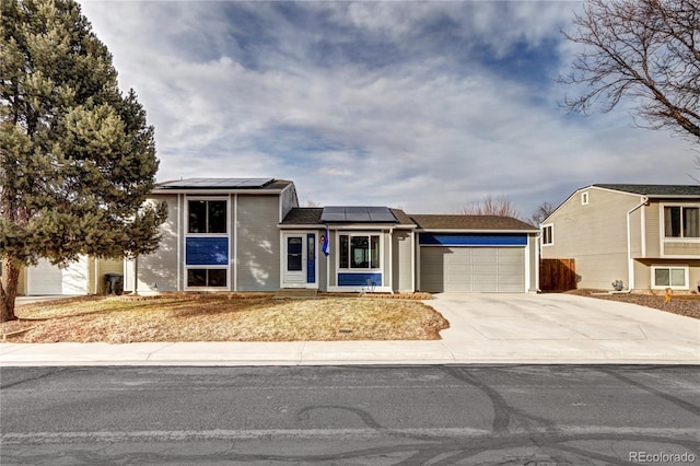 view of front of house featuring a garage and solar panels