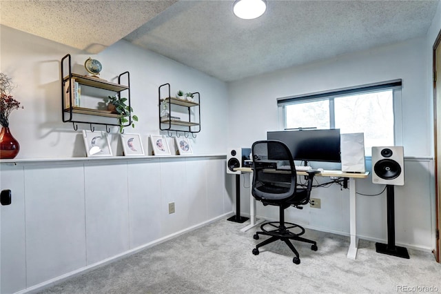 carpeted office with a textured ceiling