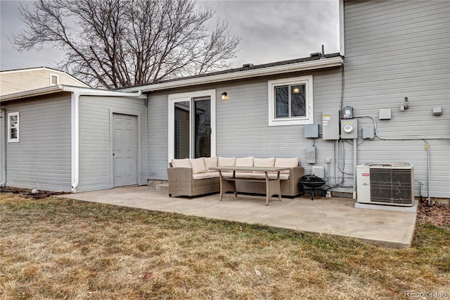 rear view of property with a lawn, outdoor lounge area, central AC, and a patio area