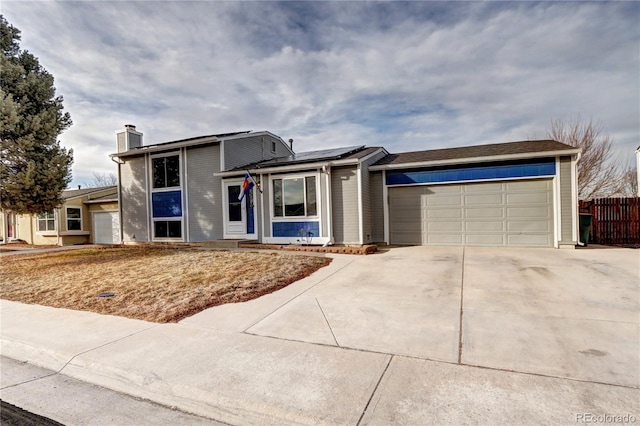 view of front of home with a garage and solar panels