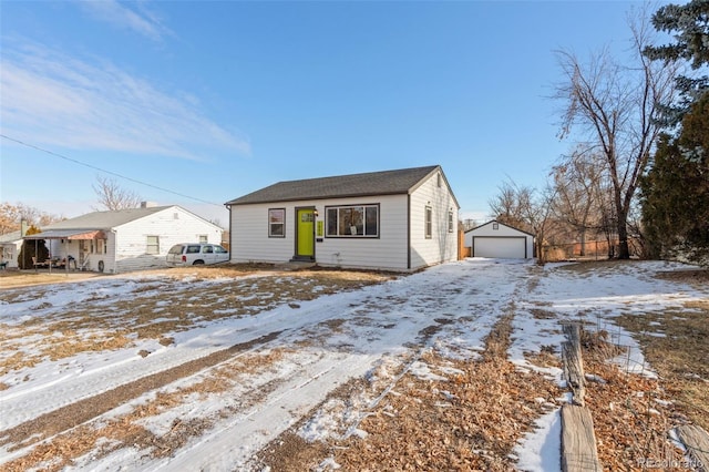 view of front of property with a garage and an outbuilding