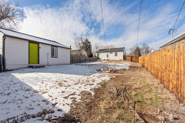 snow covered property featuring an outbuilding