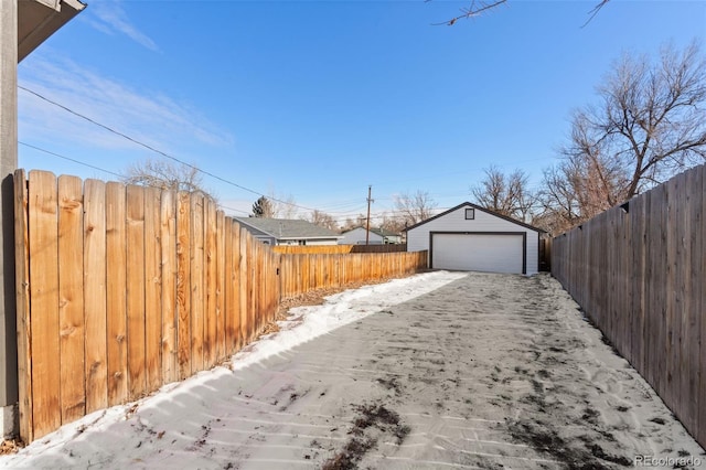 exterior space featuring a garage and an outbuilding