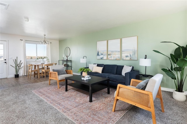 living room featuring an inviting chandelier and hardwood / wood-style floors