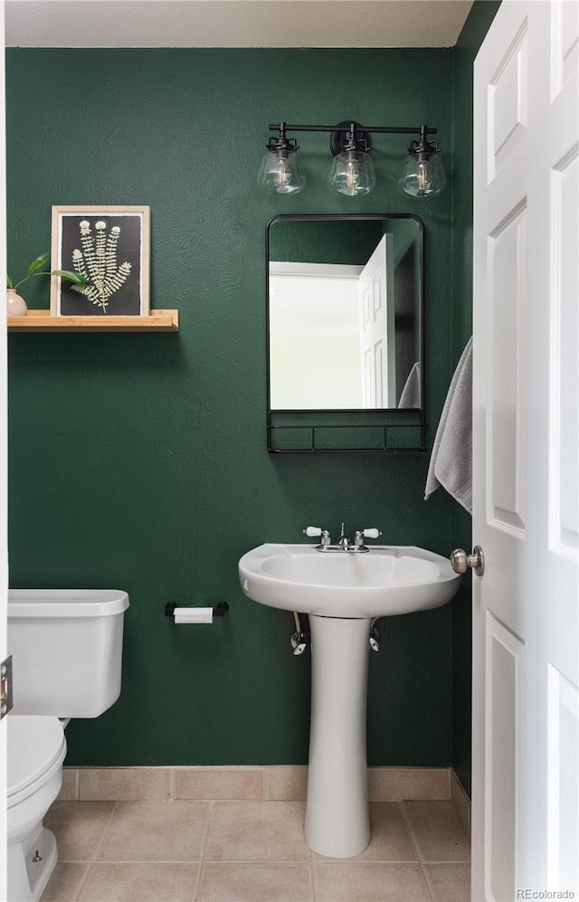 bathroom with tile patterned floors and toilet