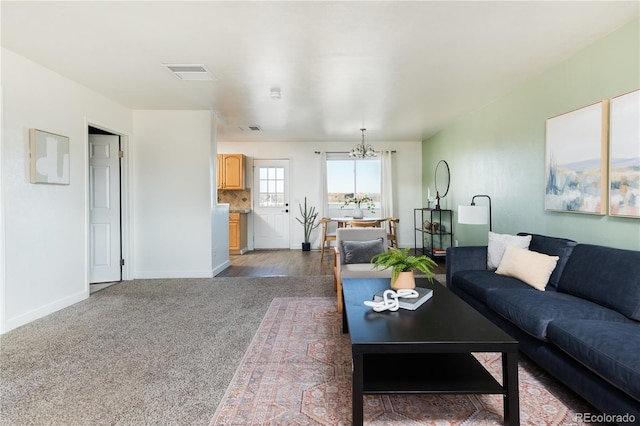 living room featuring carpet flooring and a notable chandelier