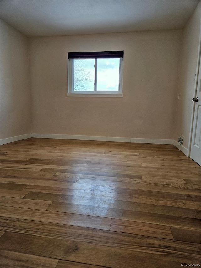 spare room with light wood-type flooring