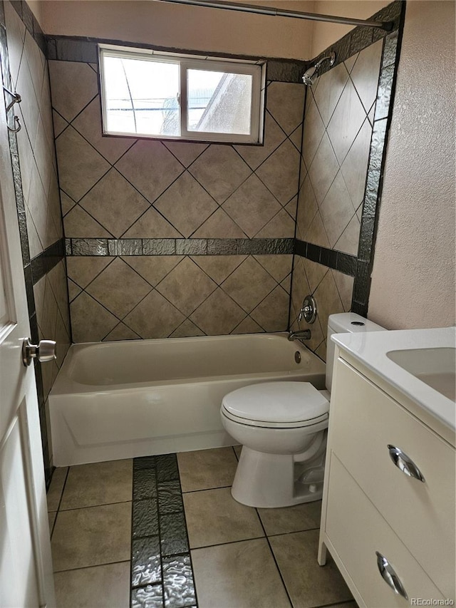 full bathroom with vanity, tile patterned flooring, toilet, and tiled shower / bath