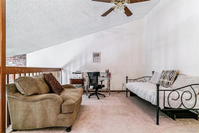 interior space featuring ceiling fan, lofted ceiling, carpet flooring, and a textured ceiling