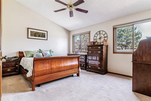 bedroom featuring vaulted ceiling, light carpet, ceiling fan, and a textured ceiling