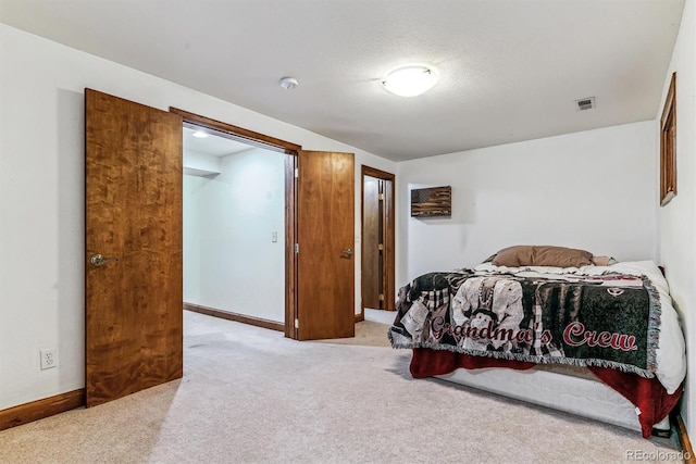 carpeted bedroom featuring a textured ceiling