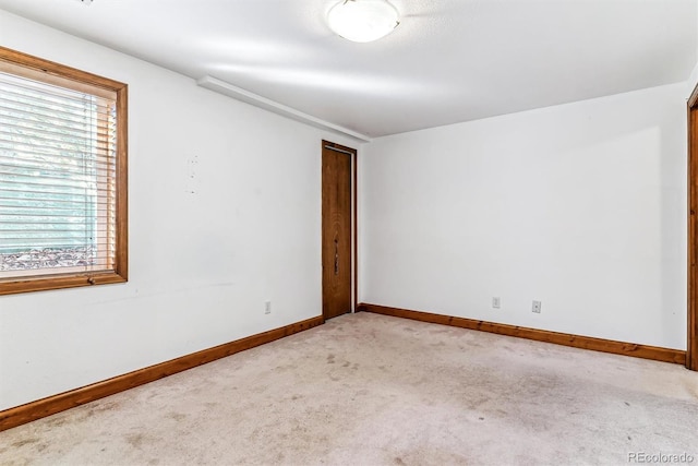 spare room with light colored carpet