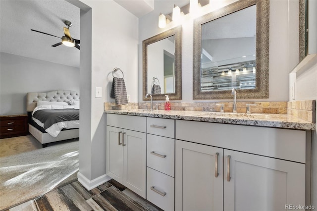 bathroom featuring vanity, lofted ceiling, hardwood / wood-style flooring, ceiling fan, and a textured ceiling