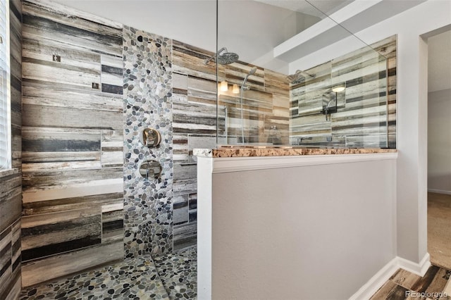 bathroom featuring a tile shower and hardwood / wood-style floors