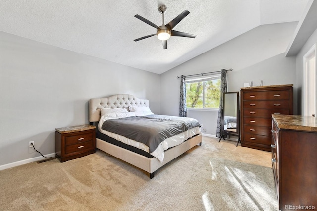 carpeted bedroom with a textured ceiling, ceiling fan, and vaulted ceiling