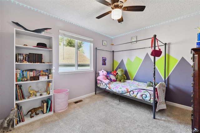 bedroom with carpet, ceiling fan, and a textured ceiling