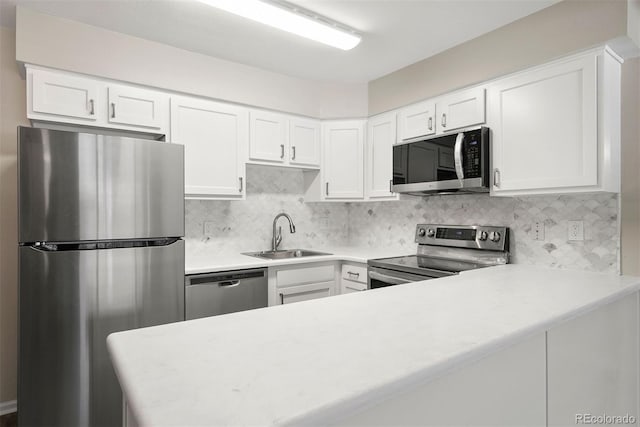 kitchen featuring appliances with stainless steel finishes, sink, and white cabinets