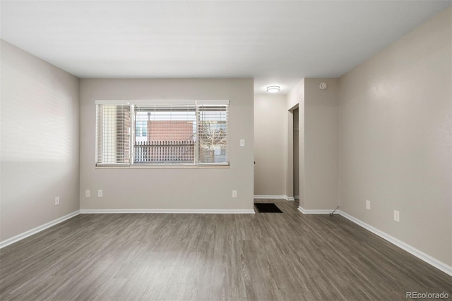 unfurnished room with dark hardwood / wood-style floors