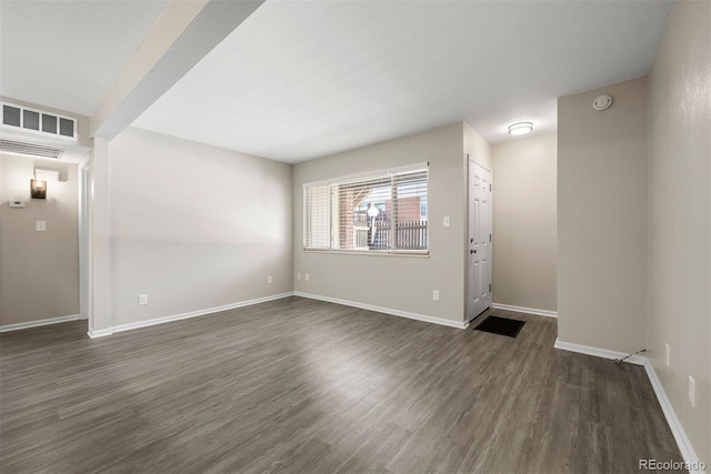 spare room featuring dark hardwood / wood-style floors